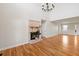 Inviting living room with hardwood floors, a painted brick fireplace, and ample natural light at 5692 Rock Patch Rd, Loganville, GA 30052