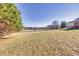 View of the fenced property and home's exterior, showing the lush green lawn at 5692 Rock Patch Rd, Loganville, GA 30052