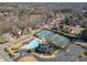 Wide aerial view of the neighborhood amenities including a pool, tennis courts, and surrounding homes at 1865 Valley Brook Dr, Alpharetta, GA 30005