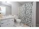 Clean, well-maintained bathroom with a patterned shower curtain, tile floor, and a bright vanity at 2426 Westland Way, Acworth, GA 30102