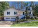 Charming yellow home featuring a two-car garage and a welcoming front porch with landscaped front yard at 2426 Westland Way, Acworth, GA 30102