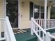 Cozy front porch with white railings, green floor, and door with storm door at 2426 Westland Way, Acworth, GA 30102