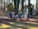 A secluded backyard features a fire pit surrounded by Adirondack chairs, creating a cozy and inviting outdoor space at 4025 Gretna Green Dr, Decatur, GA 30035