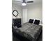 Cozy bedroom featuring a ceiling fan, a large mirror, and a comfortable bed with stylish bedding at 4025 Gretna Green Dr, Decatur, GA 30035
