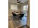 Modern dining room featuring seating for six, a stylish ceiling fan, and natural light from the sliding doors at 4025 Gretna Green Dr, Decatur, GA 30035