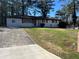 Charming single-story home with a well-manicured front yard and a concrete driveway at 4025 Gretna Green Dr, Decatur, GA 30035