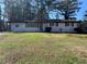Single-story home with a well-manicured lawn and a cozy, inviting facade at 4025 Gretna Green Dr, Decatur, GA 30035