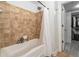 Well-lit bathroom featuring a tub, shower, and ceramic tile wall at 200 River Vista Dr # 608, Atlanta, GA 30339