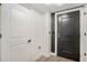 Modern entryway featuring gray vinyl flooring and a black front door with modern hardware at 200 River Vista Dr # 608, Atlanta, GA 30339