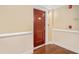 Hallway with a stained wood door with a brass number and a staircase sign at 200 River Vista Dr # 608, Atlanta, GA 30339