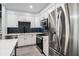 Well-equipped kitchen boasting stainless steel appliances, sleek white cabinets, and a stylish backsplash at 200 River Vista Dr # 608, Atlanta, GA 30339