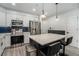 Modern kitchen with stainless steel appliances, island with bar stools, and clean design at 200 River Vista Dr # 608, Atlanta, GA 30339