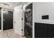 A laundry room includes a modern, stacked washer and dryer at 200 River Vista Dr # 608, Atlanta, GA 30339