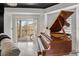 The natural light is emphasized in this stunning living area with piano and outdoor view at 200 River Vista Dr # 608, Atlanta, GA 30339