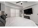 Comfortable bedroom featuring large windows, modern ceiling fan and sleek black fireplace under TV at 200 River Vista Dr # 608, Atlanta, GA 30339