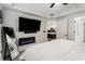 Bright bedroom with a large TV, modern fireplace, and an open doorway to the kitchen at 200 River Vista Dr # 608, Atlanta, GA 30339