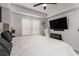 Comfortable bedroom featuring large windows, modern ceiling fan and sleek black fireplace under TV at 200 River Vista Dr # 608, Atlanta, GA 30339