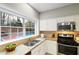 Kitchen featuring granite countertops, stainless steel appliances and a large window overlooking the pool at 2956 Stanstead Cir, Norcross, GA 30071