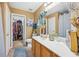 Bathroom featuring modern sink, cabinets, mirror, and walk-in closet at 7595 Waverly Loop, Fairburn, GA 30213