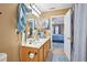 Well-lit bathroom with a large mirror, neutral color palette, and decorative accents provides a tranquil retreat at 7595 Waverly Loop, Fairburn, GA 30213