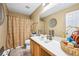 Bathroom with vanity and toilet with a shower with patterned curtain at 7595 Waverly Loop, Fairburn, GA 30213