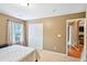 Neutral bedroom with an entrance visible to a living area with hardwood floors at 7595 Waverly Loop, Fairburn, GA 30213