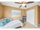 Comfortable looking bedroom with a ceiling fan and carpeted floors at 7595 Waverly Loop, Fairburn, GA 30213