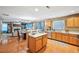 Open kitchen with stainless steel appliances and a view into the adjacent living and dining areas at 7595 Waverly Loop, Fairburn, GA 30213