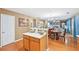 Bright kitchen with modern appliances, wooden cabinetry, and seamless flow into the adjoining living area at 7595 Waverly Loop, Fairburn, GA 30213