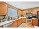 Traditional-style kitchen featuring stainless steel appliances, and light wood cabinets at 7595 Waverly Loop, Fairburn, GA 30213