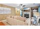 Comfortable living area featuring a decorative fireplace, plush seating, and view into the dining area at 7595 Waverly Loop, Fairburn, GA 30213