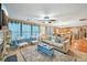 Open-concept living room with stylish furniture, fireplace, and seamless flow into the adjacent kitchen at 7595 Waverly Loop, Fairburn, GA 30213