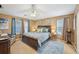 Spacious main bedroom with a ceiling fan and soft natural lighting at 7595 Waverly Loop, Fairburn, GA 30213