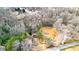 High aerial view of the red home, scenic pond, and tree-lined surroundings at 257 Crossroads Church Rd, Rockmart, GA 30153