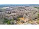 Expansive aerial view showcasing the red home, pond, and surrounding landscape at 257 Crossroads Church Rd, Rockmart, GA 30153