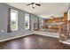 Open living room and view to the kitchen featuring wood floors and large windows at 257 Crossroads Church Rd, Rockmart, GA 30153