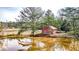 Charming red home with a pond, offering a serene and picturesque setting at 257 Crossroads Church Rd, Rockmart, GA 30153