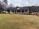 Spacious backyard with a covered patio, ideal for outdoor entertaining and relaxation at 215 Buck Run, Loganville, GA 30052