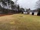 Large backyard with an outbuilding and plenty of space for outdoor activities and recreation at 215 Buck Run, Loganville, GA 30052