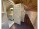 Bathroom entrance from bonus room featuring hardwood floors and white vanity at 215 Buck Run, Loganville, GA 30052