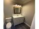 This bathroom features a single vanity, framed mirror, and tile backsplash at 215 Buck Run, Loganville, GA 30052