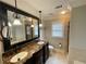 This bathroom features double sinks with decorative light fixtures and large mirror at 215 Buck Run, Loganville, GA 30052