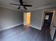 This bedroom features gray hardwood floors, neutral paint, and access to a bathroom at 215 Buck Run, Loganville, GA 30052