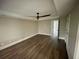 This bedroom features hardwood floors with a neutral paint and ceiling fan at 215 Buck Run, Loganville, GA 30052
