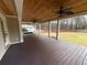 Spacious covered patio with a wood ceiling, ceiling fans, and a hot tub for relaxation at 215 Buck Run, Loganville, GA 30052