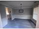 Chic dining room with decorative wainscoting, modern light fixture and view into kitchen at 215 Buck Run, Loganville, GA 30052