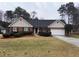 Charming brick home featuring manicured landscaping and a well-maintained front yard at 215 Buck Run, Loganville, GA 30052