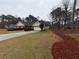 Well-maintained home with a long driveway, manicured lawn, and mature trees at 215 Buck Run, Loganville, GA 30052