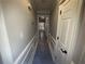 Bright hallway with white trim, gray walls, and hardwood floors lead to other rooms in the home at 215 Buck Run, Loganville, GA 30052