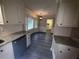 Well-equipped kitchen featuring granite counters, white cabinets, and modern appliances at 215 Buck Run, Loganville, GA 30052